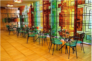 The Image of a glass wall that has multicolored square shaped patterns