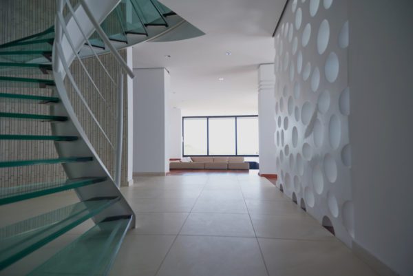 Image of a spiral glass stairs in contemporary hallway