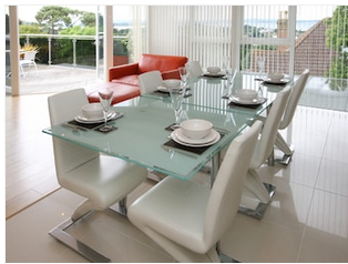 The image of a clear Glass Table in a dining room